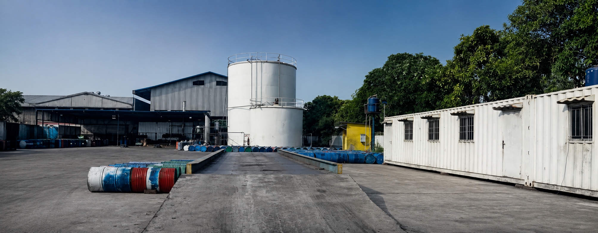 Exterior view of the storage tanks, warehouse building, and weighbridge at BSN's facility